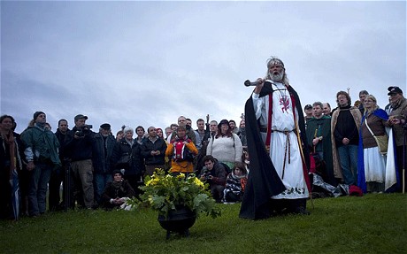 Chief druid Arthur Pendragon leads incantations during the summer solstice ceremony: Traditional British downpour for ancient Stonehenge midsummer rituals